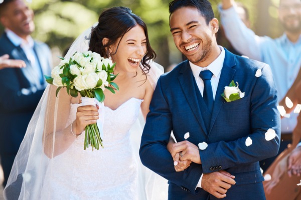 Newlywed couple smiling at wedding